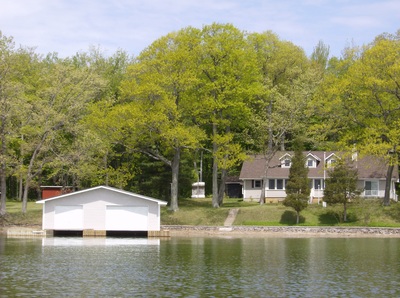 Picture from the river of a custom built cottage and boathouse on Grenadier Island located in the 1000 Islands.